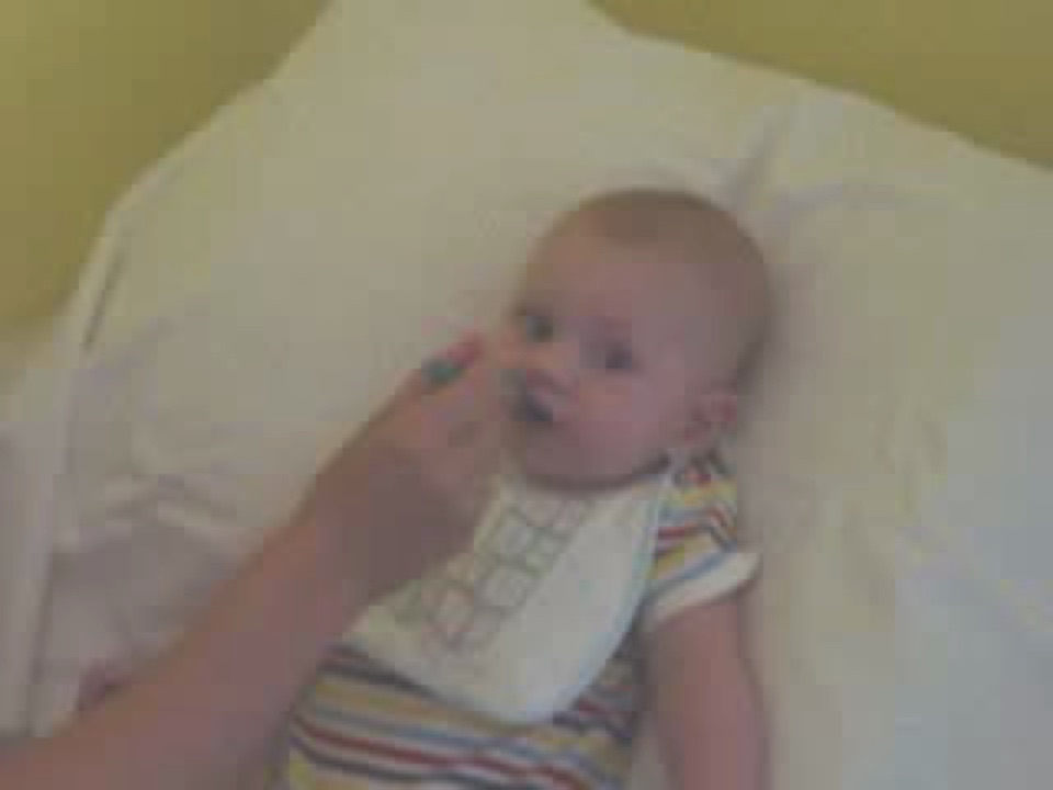 Alex's first solid meal! Mashed carrots and sweet potato - yum yum! We narrowly missed catching the bit where he screwed up his face.