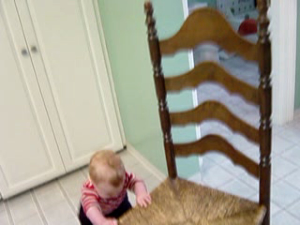 Alex pushes a chair across the kitchen floor.