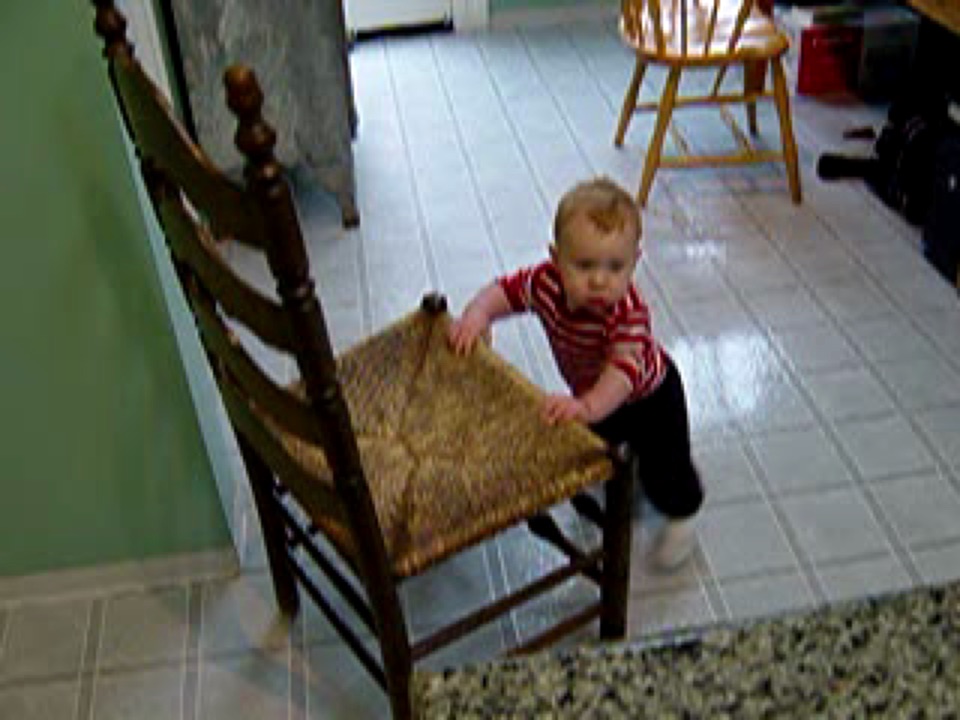 Alex pushes the same chair, gets it stuck, then grunts about it.