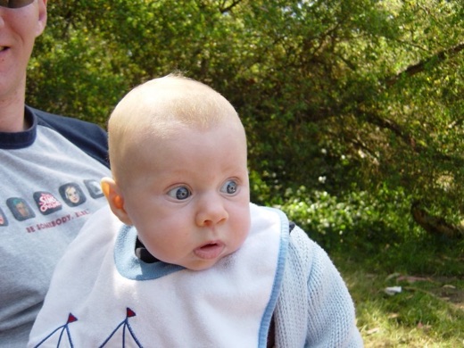 Here little Alex puts on a funny face while being burped. Rule#1 was 'No throwing up on daddy'. That didn't last very long.