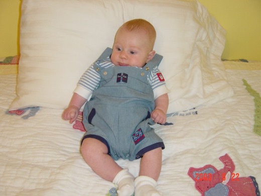 Alex lying on a pillow. It took several shots, and much coaxing by mummy and daddy before he looked in our direction.
