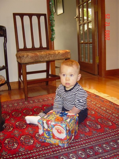 Here's little Alex opening some of his many Christmas presents. Typically, he enjoyed ripping (and eating) the wrapping paper more.